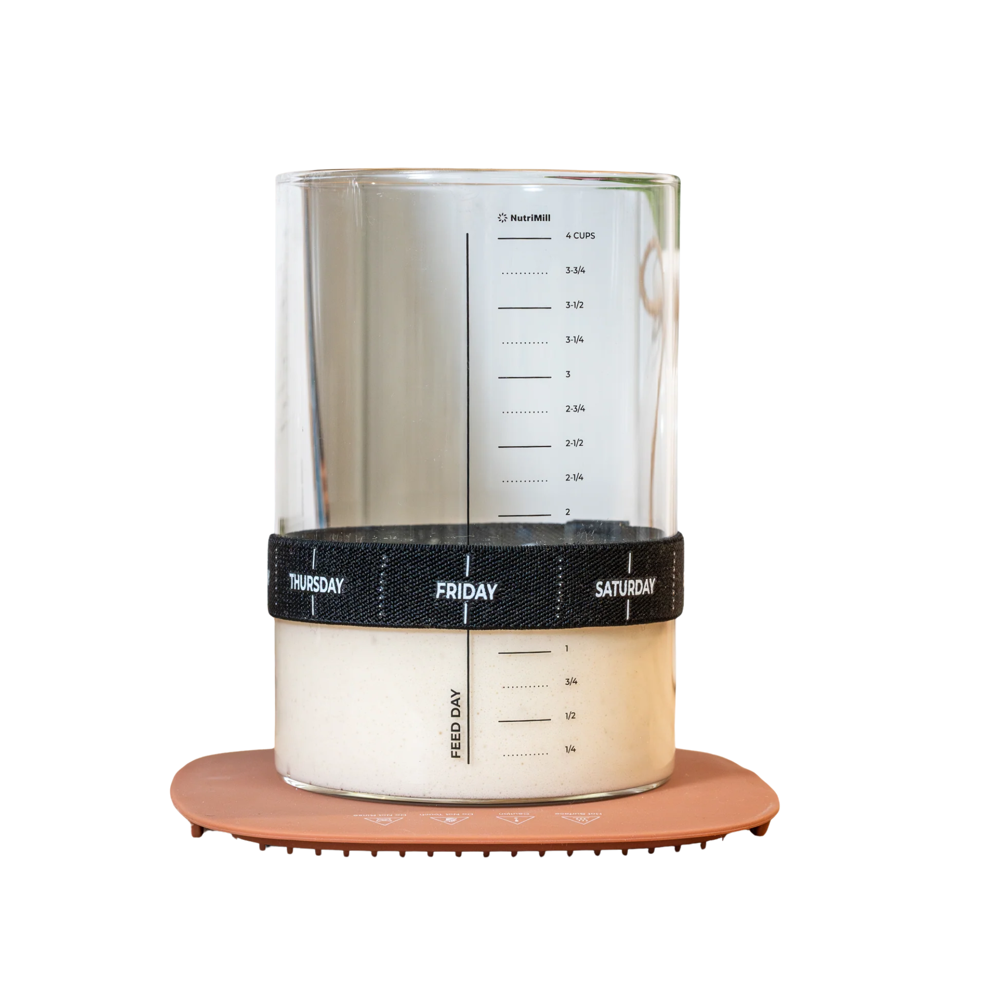 Clear container with measurement markings, black band labeled with days, and a silicone base for sourdough warming.