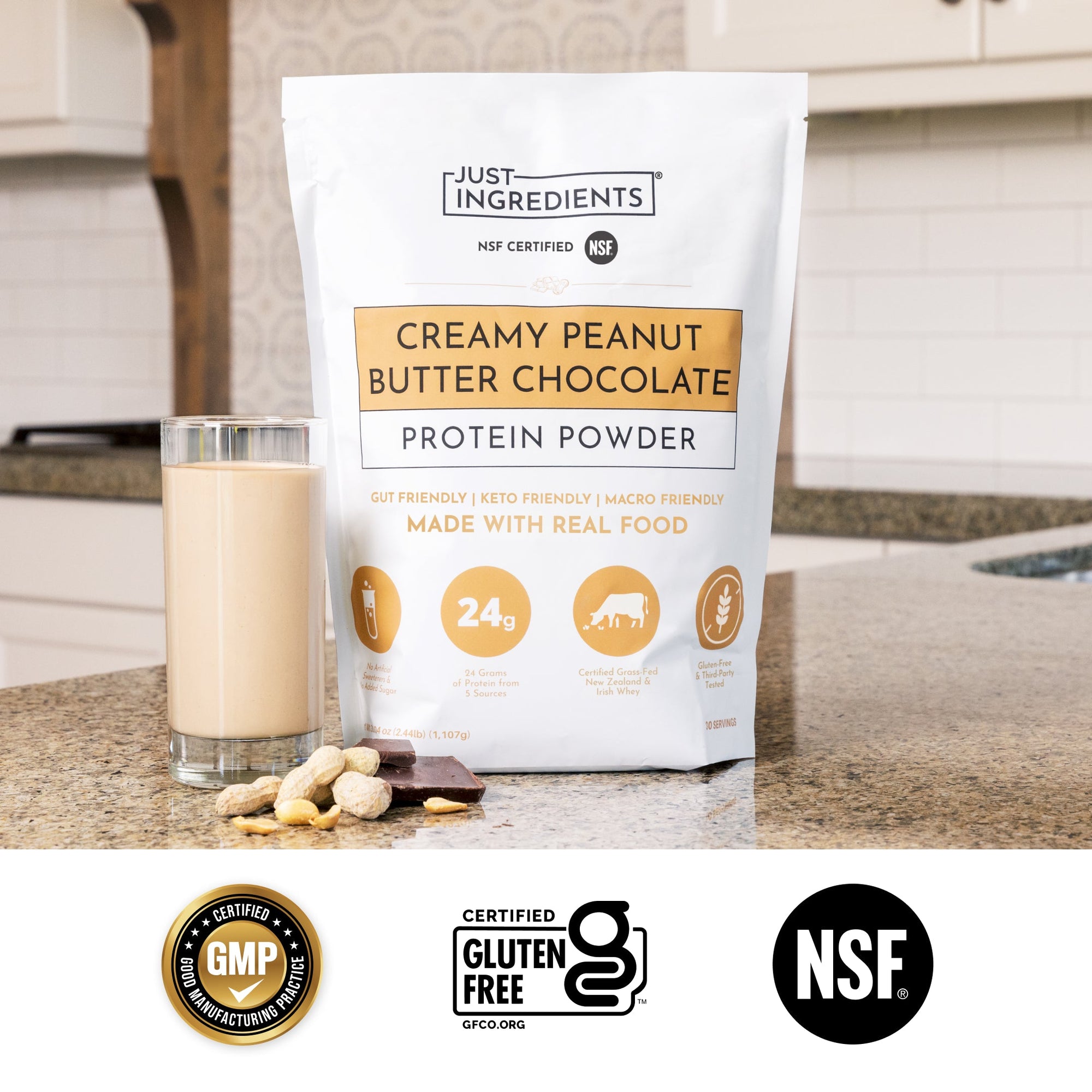Product package with sample packet and chocolate pieces beside a small scoop of powder