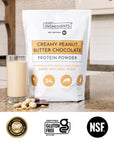 Product package with sample packet and chocolate pieces beside a small scoop of powder