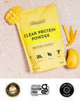 Hand holding yellow Frosted Mango Clear Protein Powder pouch with product icons and packaging details.