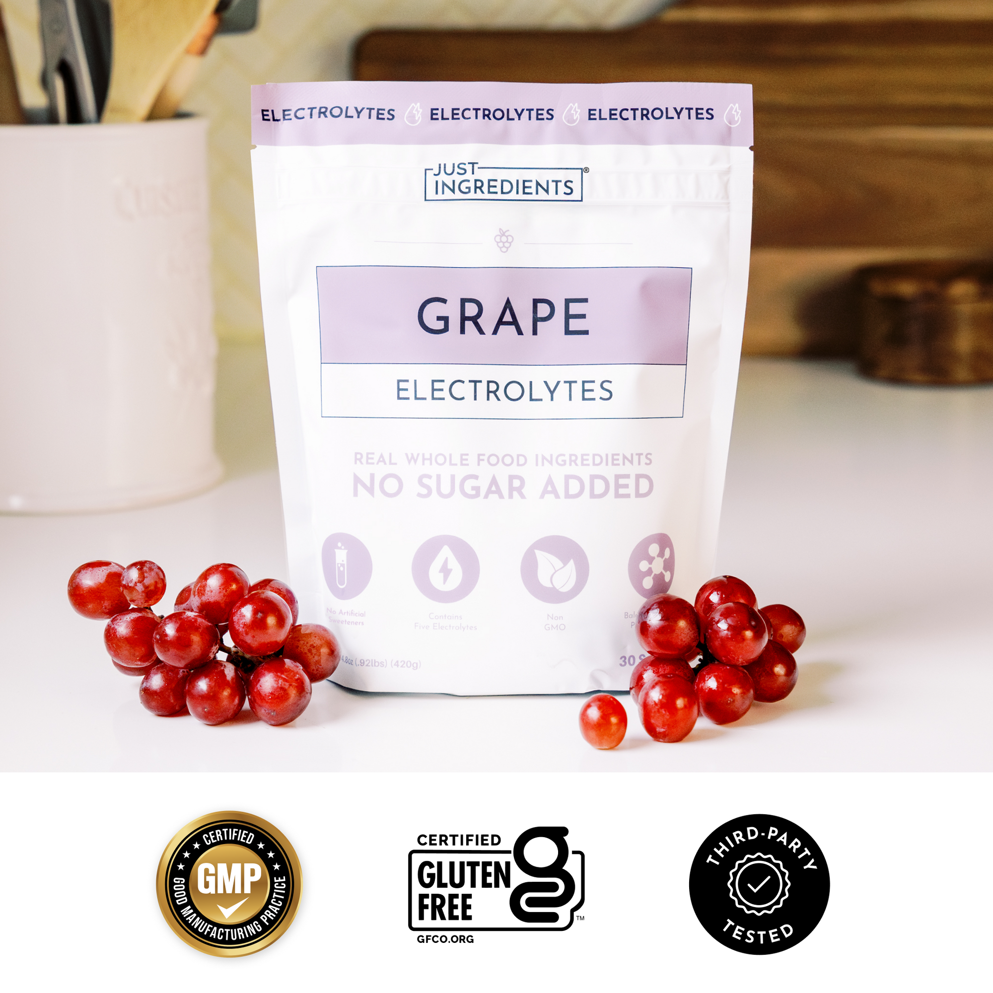 Colorful scoops of grape electrolyte powder on a pink background with a checkmark feature list.