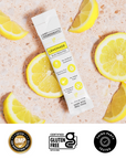 Lemonade electrolytes stick beside lemon slices on marble surface with packaging information visible