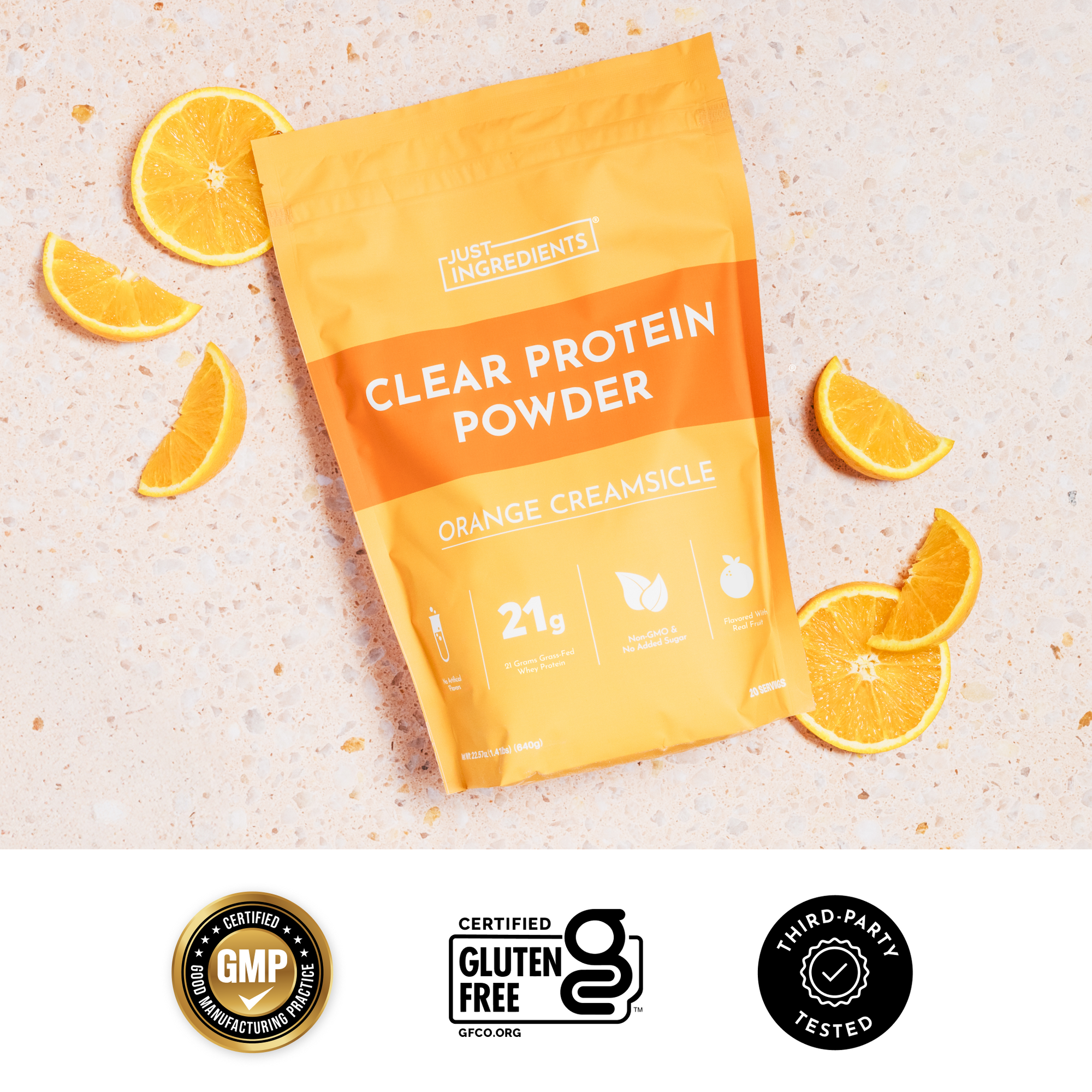Clear orange creamsicle protein drink poured into a glass with the product pouch visible, highlighting 21g protein.