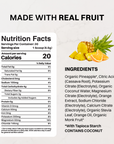 Orange Pineapple stick packet labeled "Orange Pineapple Pre-Workout" beside fresh pineapple slices on a marble surface.